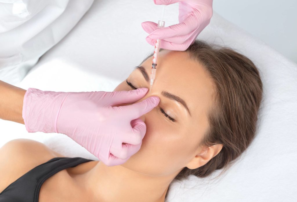 A Woman receiving Injection on nose | Get Botox at Golden Medical Aesthetics in Meridian, ID
