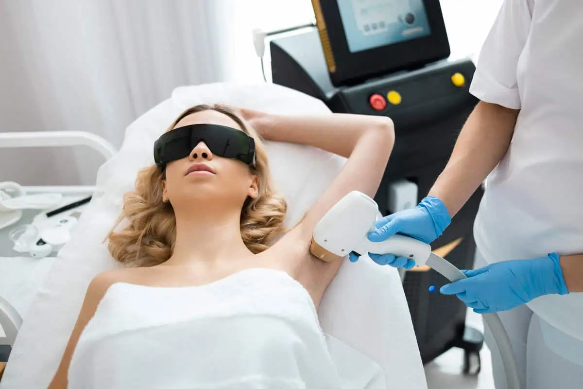 Beautiful woman getting diolaze laser hair removal on her armpits at Golden Medical Aesthetics.