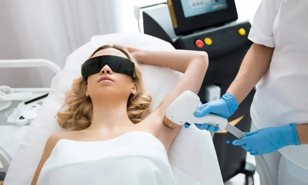 Beautiful woman getting diolaze laser hair removal on her armpits at Golden Medical Aesthetics.